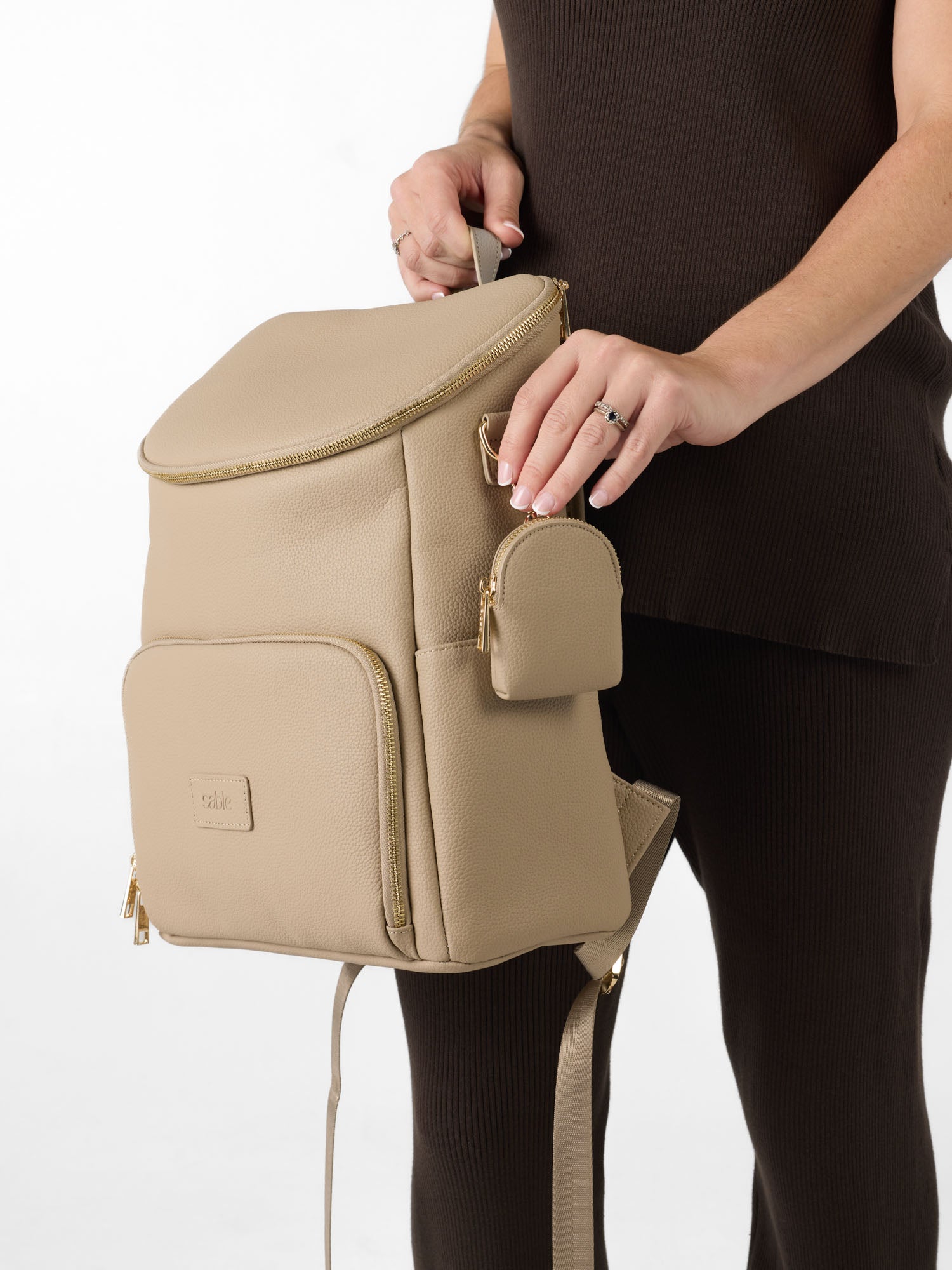 Vegan leather nappy backpack with matching dummy pouch attached for easy access to baby essentials