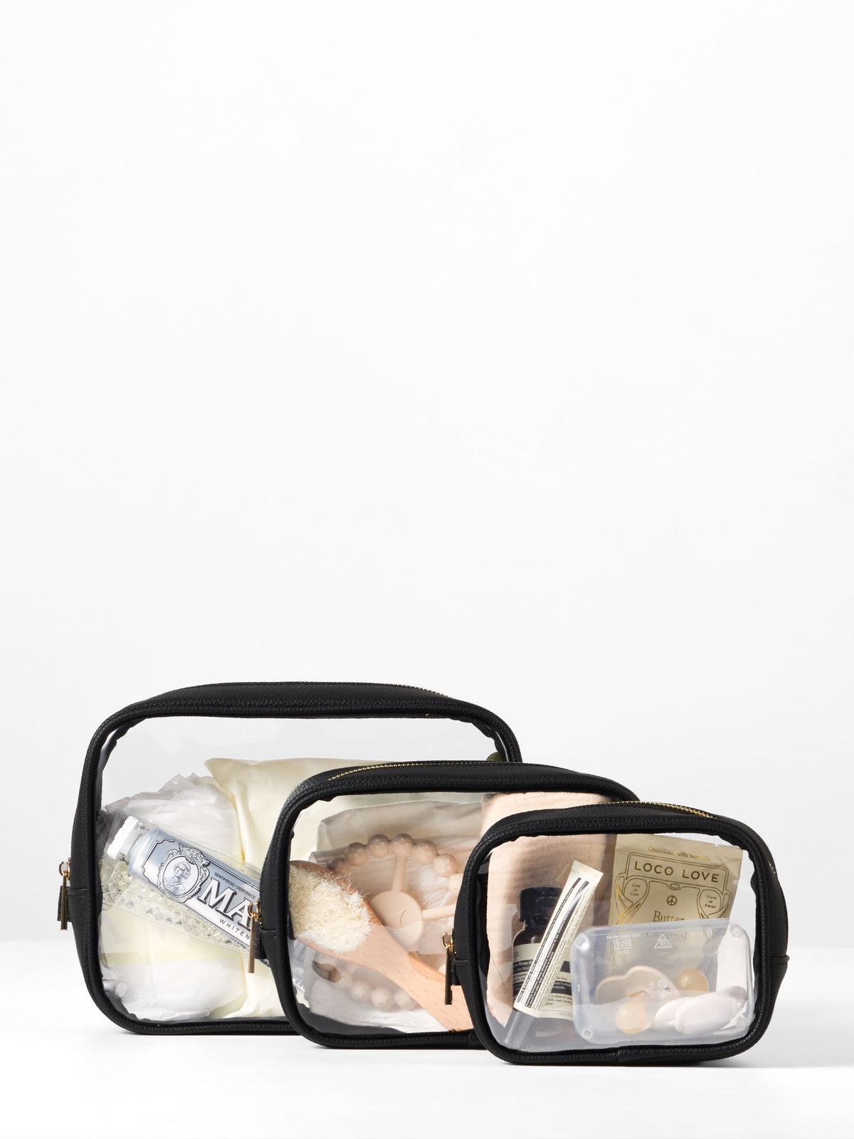 Black-trim clear organiser cases packed with skincare, a brush and a dummy