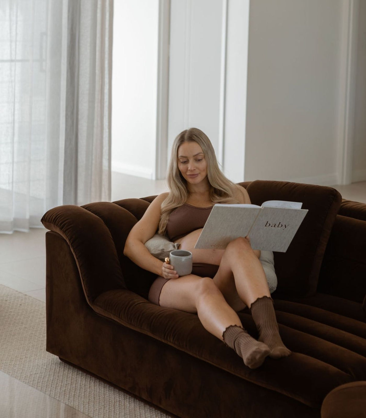 nursing pillow being used as pregnancy support. Use it to support your growing bump and find a more comfortable position while resting or relaxing - sable bebe