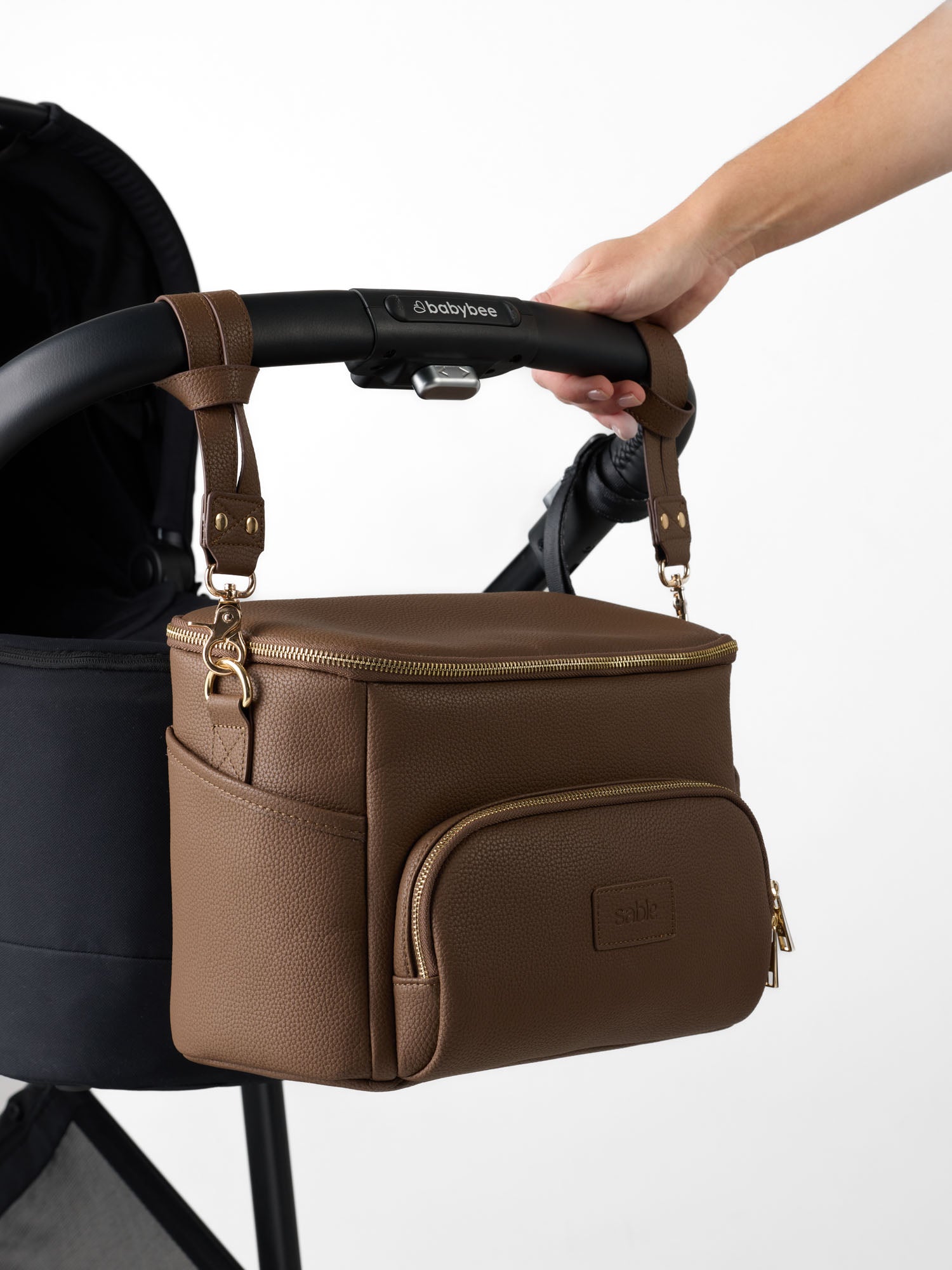 Vegan leather pram organiser in chocolate brown with stroller attachment straps