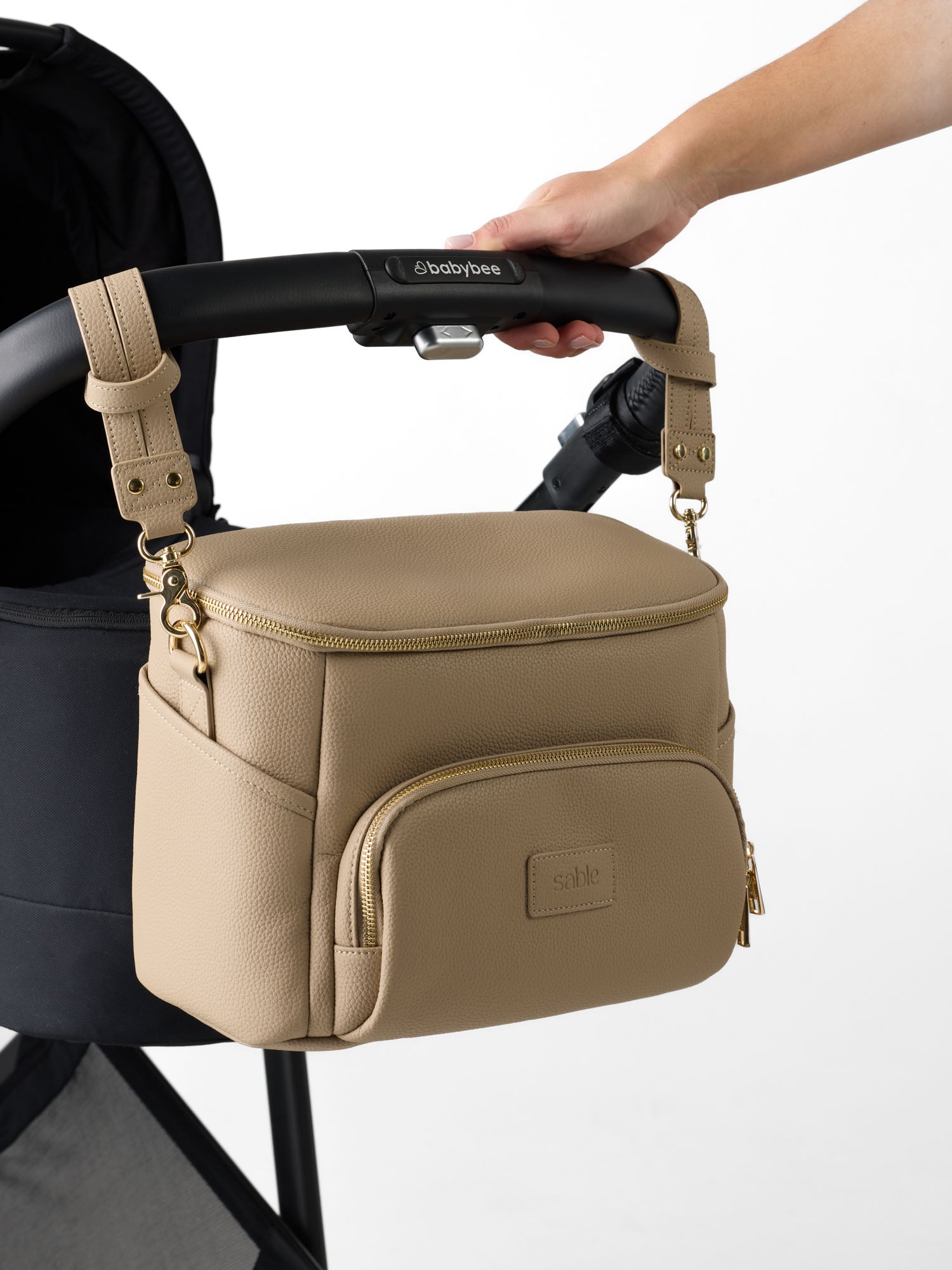 Stroller organiser with insulated bottle pockets and storage for nappies, wipes and daily essentials