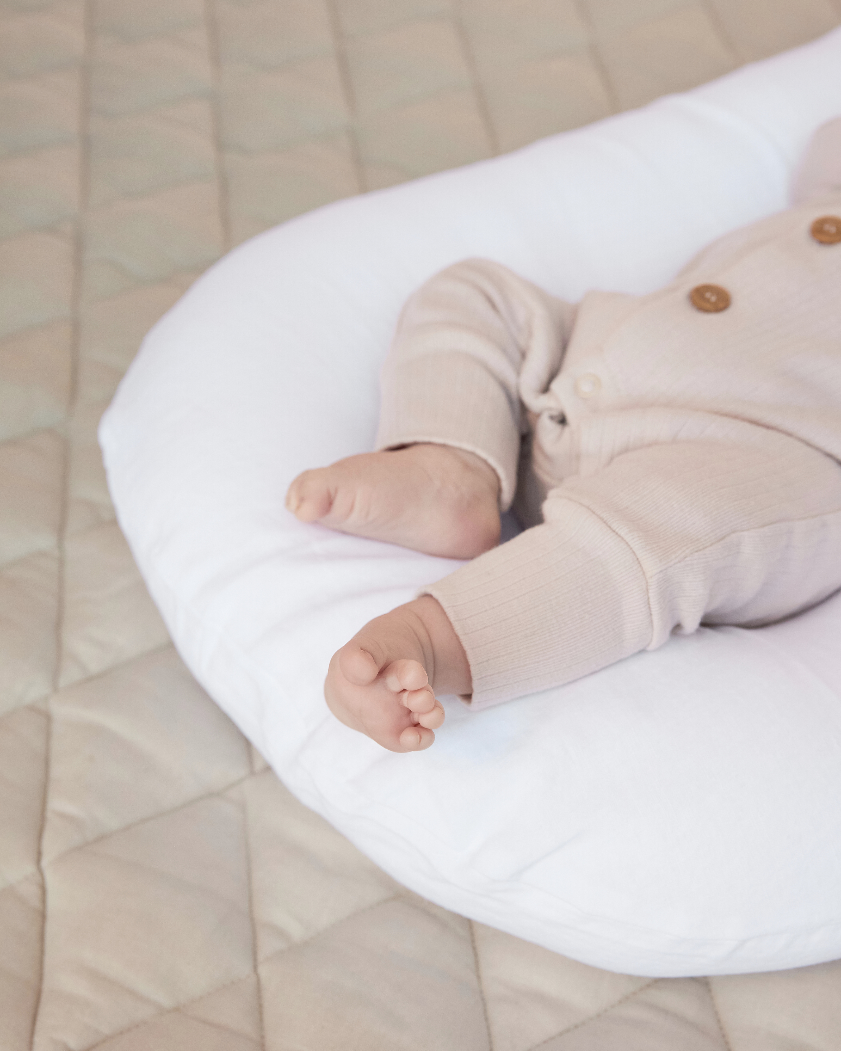 Newborn lounger with soft, supportive sides
