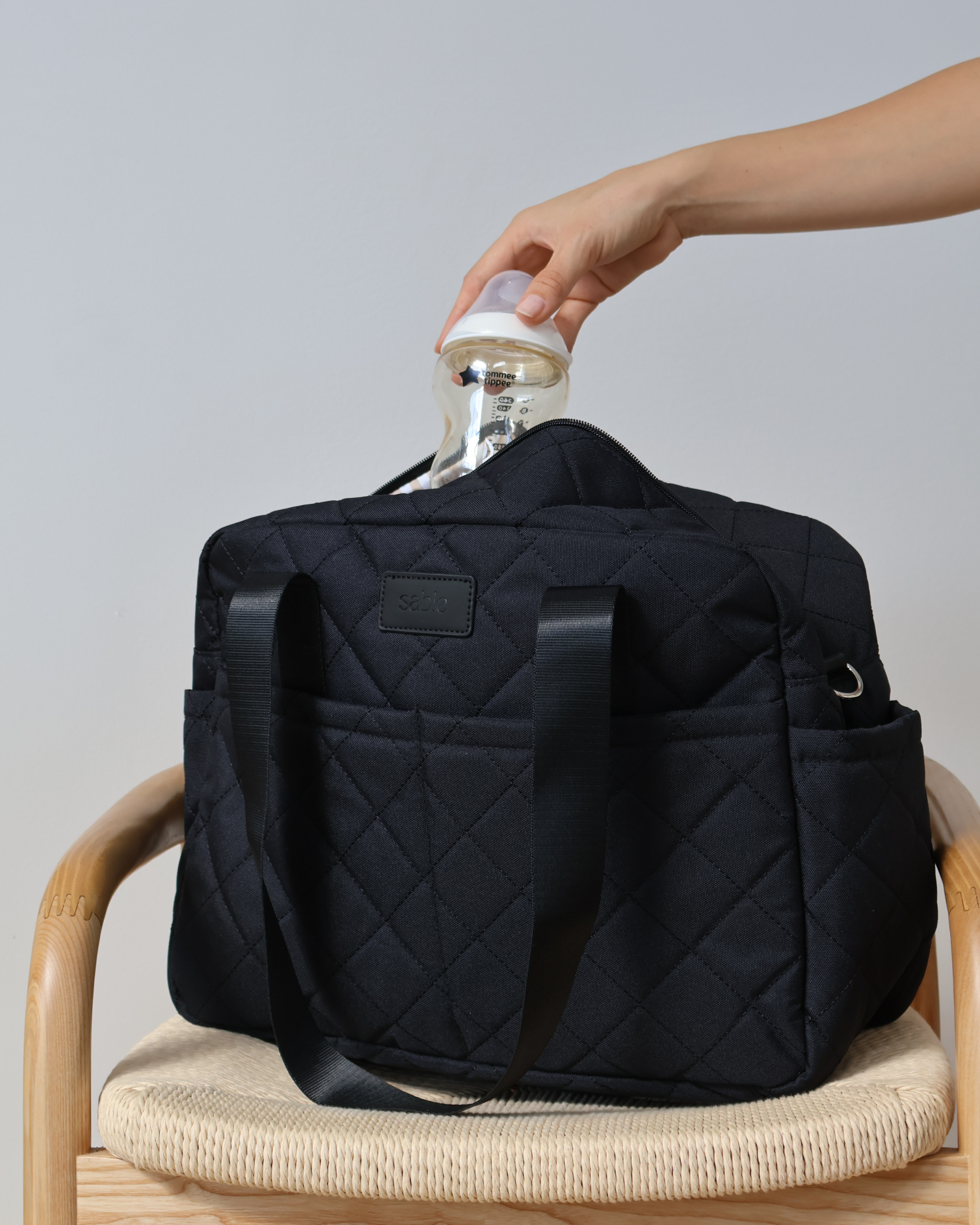 Black baby bag with multiple compartments