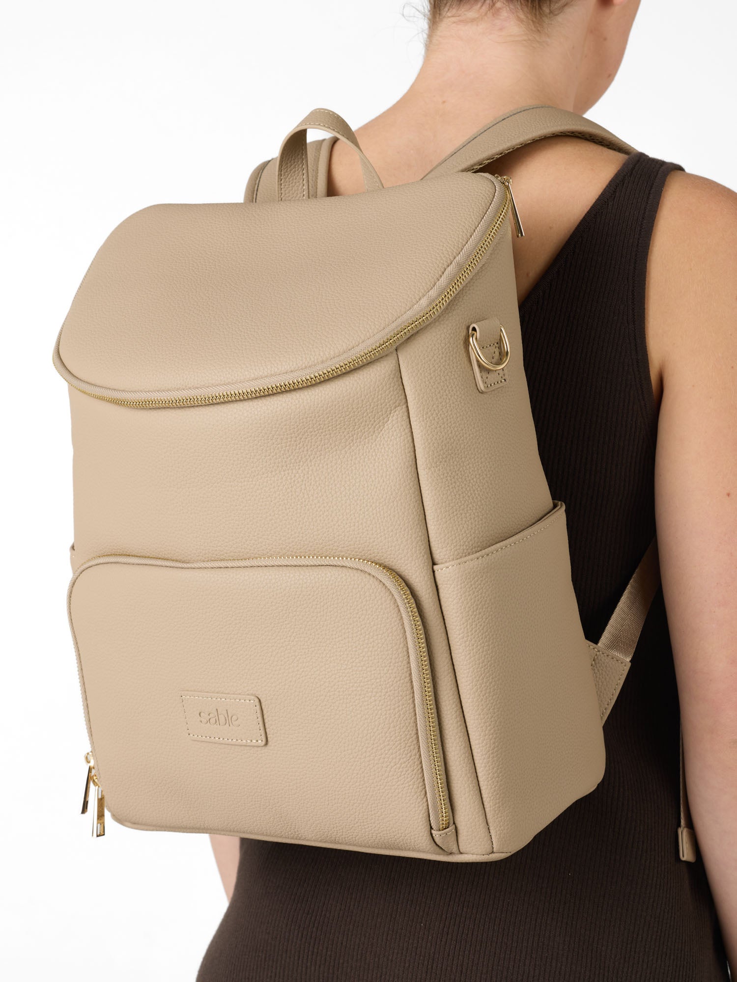 Parent wearing a vegan leather nappy backpack designed for hands-free carrying and everyday outings