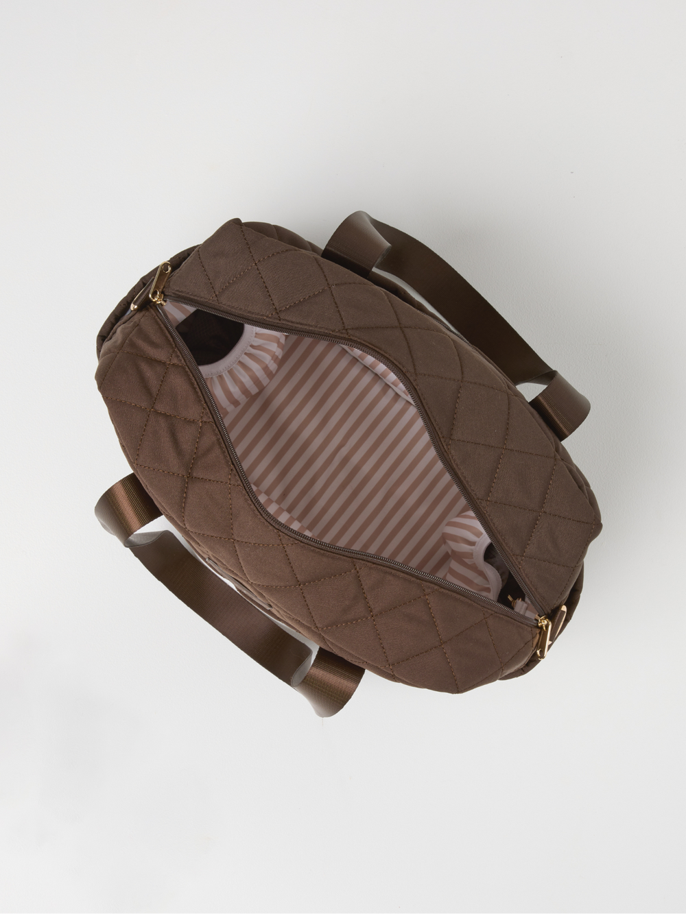 Top view of the open chocolate quilted nappy bag showing its striped lining