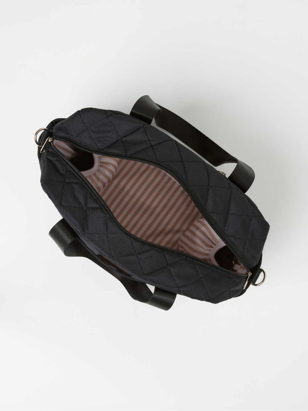Top view of the open black quilted nappy bag showing its striped lining