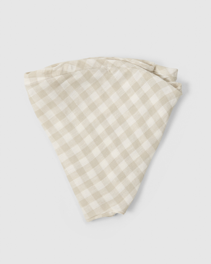 Folded linen nursing pillow cover in soft grey gingham