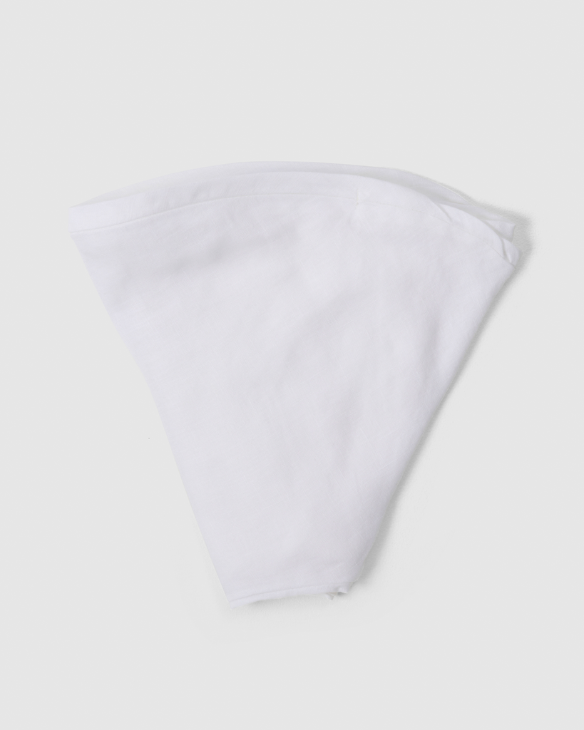 Folded linen nursing pillow cover in white