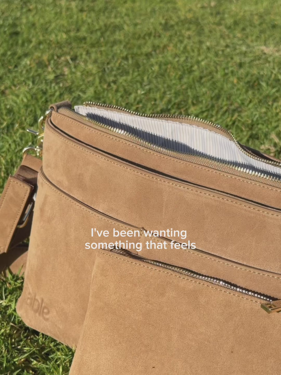 Video of the Sable Bebe Pram Caddy Bag in brown being attached to a pram and worn with the over the shoulder adjustable strap