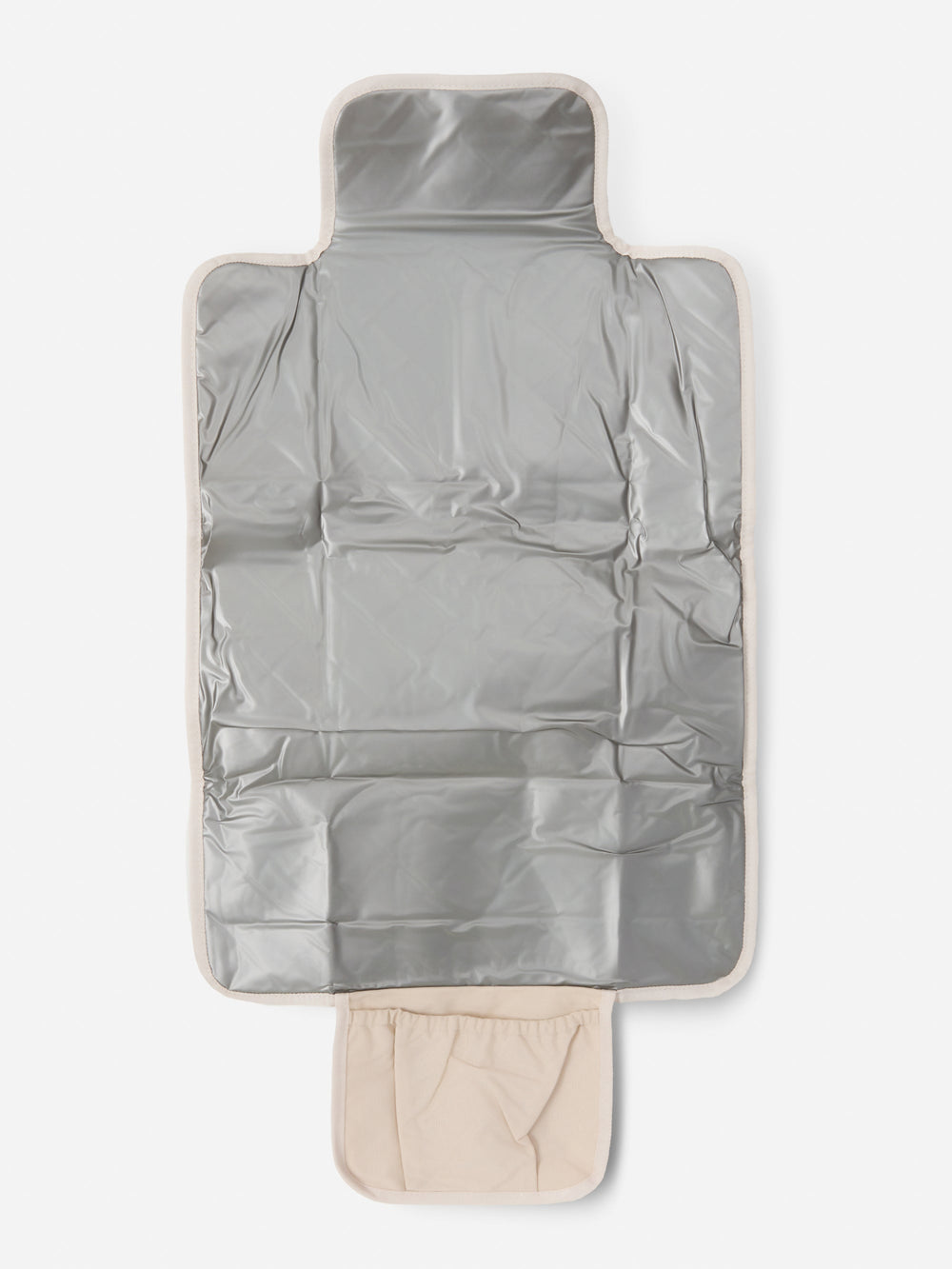Sand quilted change mat unfolded to show its wipe-clean silver lining